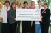 women holding large check