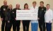 group of people holding enormous check