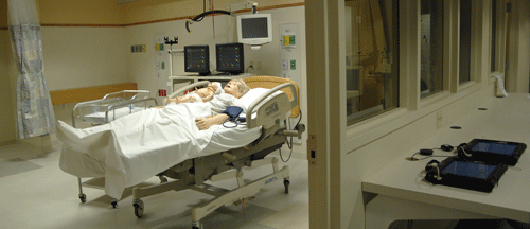 birthing simulator manikin in simulated hospital room