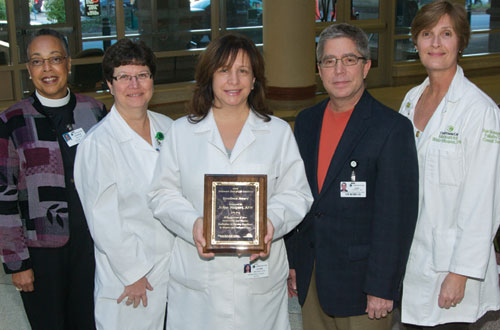 group of health professionals holding award