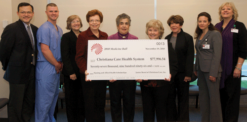 group of people with giant check