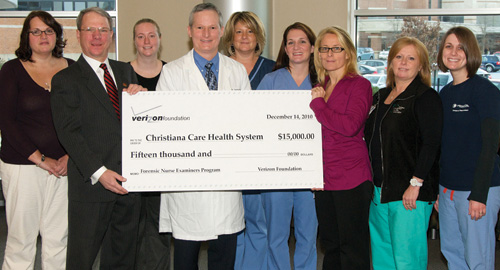 Physician and staff at check presentation