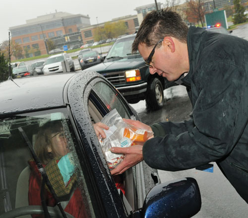 person in car turning in bag of expired medications on medication take-back day