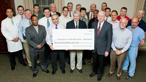 orthopaedic surgeons with giant check