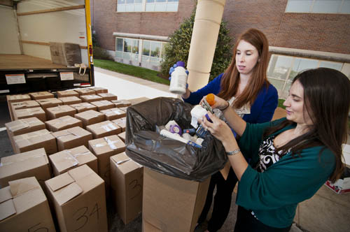 Jessica McPoland, Pharm.D (left), and Katelyn McCormick, Pharm.D, sift through some of the medications brought to the MAP 2 parking lot April 27 for disposal. At the end of the day, there were 96 boxes holding 1,948 pounds ready for proper disposal. 