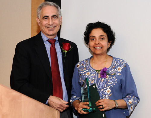 Chetana Kripalu, M.D., receives the Spirit of Women Community Hero Award from Michael Rosenthal, M.D., chair of the Department of Family and Community Medicine.