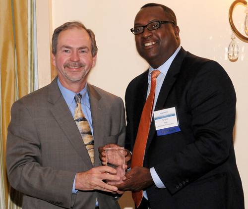 Robert J. Laskowski, M.D., MBA, president and CEO of Christiana Care Health System, receives the Delaware Bioscience Association Service Award, presented by Ty Jones, AstraZeneca director of Delaware External Affairs. 