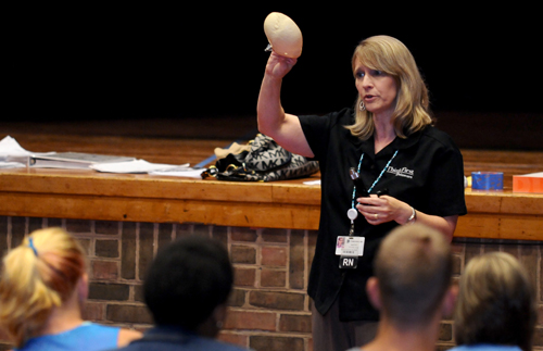 Kathy Boyer, BSN, RN, CCRN, Trauma Department injury prevention coordinator and ThinkFirst program coordinator, explains the physical consequences of a gunshot wound to students at Conrad Schools of Science. Boyer presents throughout Delaware on topics related to safety.