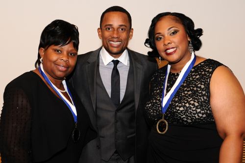 Dora Beckham and Stacy Burwell pose with actor and writer Hill Harper at the 25th annual YMCA Black Achievers in Business and Industry Awards.