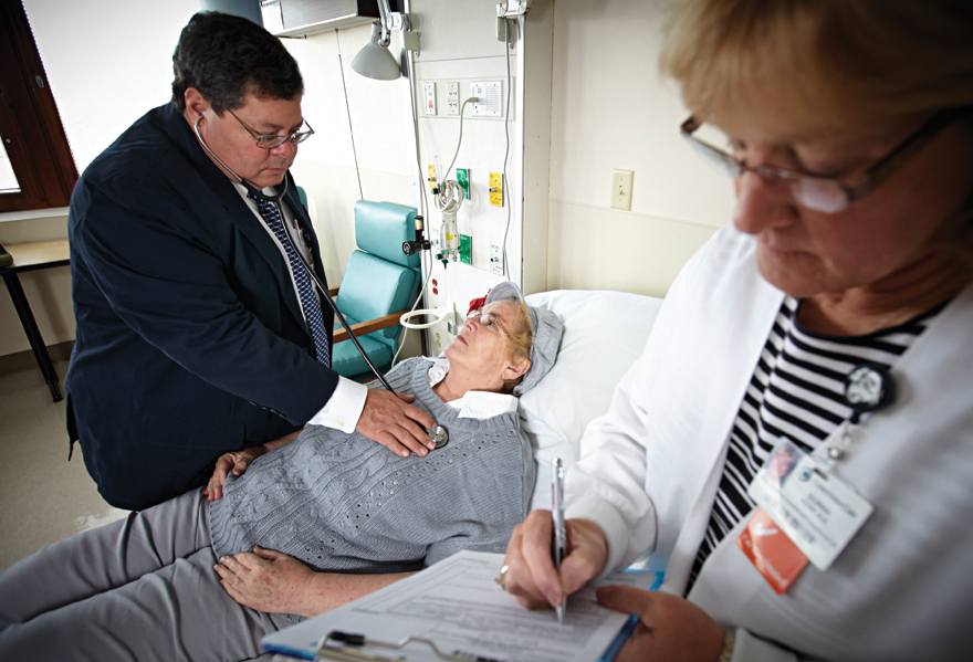 Frank Beardell, M.D., and Donna Kerr, RN, BSN, examine a patient on the Bone Marrow Transplant Unit.
