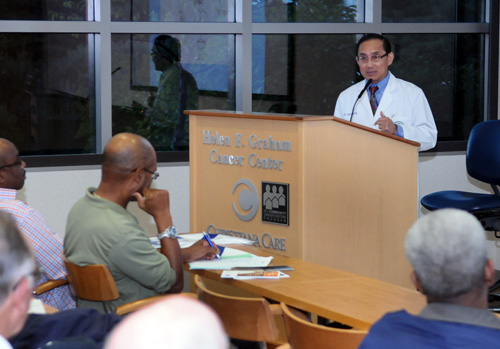 Viroon Donavanik, M.D., addresses the audience during a prostate cancer awareness seminar at the Helen F. Graham Cancer Center & Research Institute.