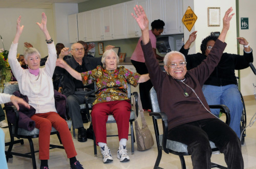 Adult Day Program friends take part in daily exercise led by staff. 