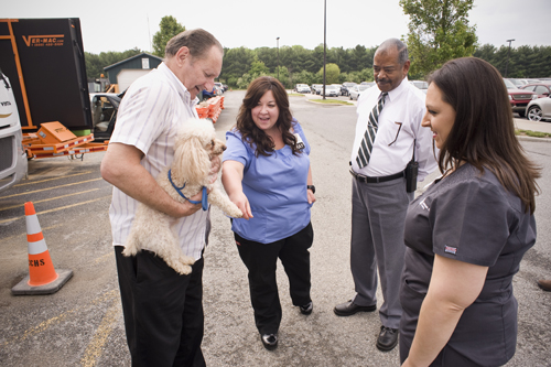 Christiana Care staff talk with George Dingwell outside his RV at Christiana Hospital. The Dingwells found home away from home at Christiana Care when their vacation was interrupted by a stroke.