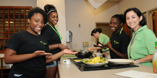 Healthy Lifestyles Coordinator Sonya Addo of the Department of Family and Community Medicine helps mentor teens learning how to prepare a heart-healthy meal in the No Heart Left Behind program, which teaches youth how to promote healthy lifestyles within their own families.