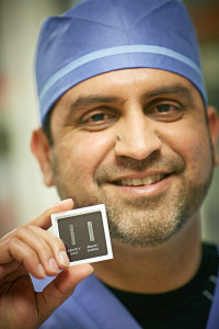Dr. Qureshi holds a small case containing two stents used in the study. The absorbable vascular scaffold stent is on the right; on the left is a traditional metallic stent.