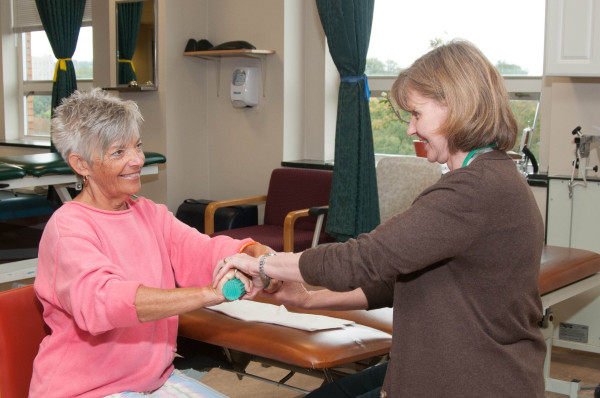 Claudia Hughes works with physical therapist Theresa Rahman on wrist-strengthening exercises at Wilmington Hospital. 