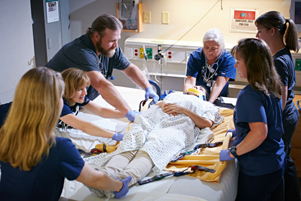 The ED-OBS care team helps to safely move a patient from a stretcher to a bed upon arrival at the Observation Unit.