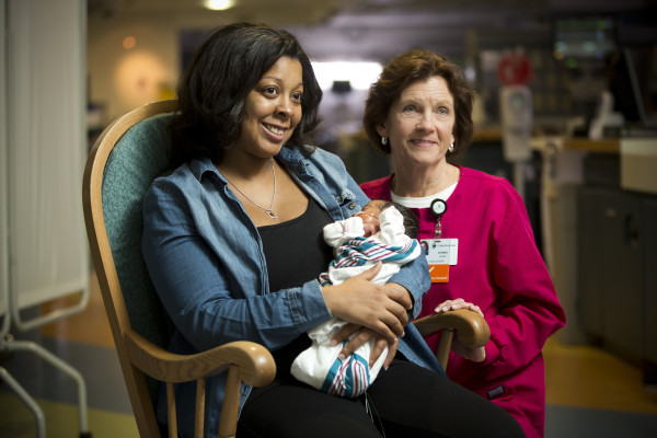 Volunteer Donna Suro shares a moment with  Jamie Chamberlain and her daughter Kendall at Christiana Care's Neonatal Intensive Care Unit.