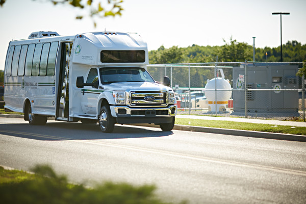 One of Christiana Care's two low-emission shuttle buses passes by the compressed natural gas fueling station on the Christiana Hospital campus. The buses are one part of Christiana Care's commitment to environmental stewardship.