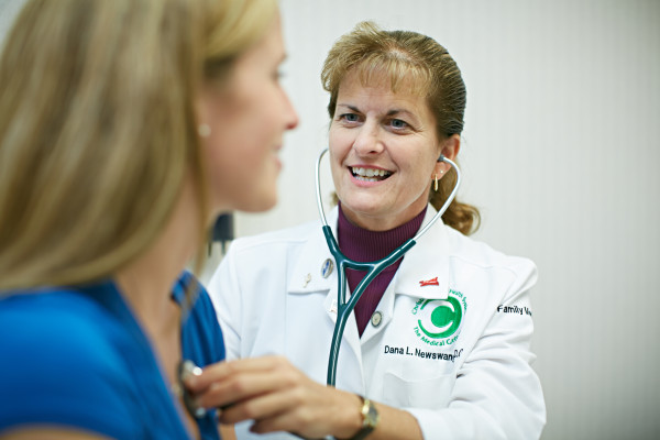 Dana Newswanger, D.O., talks with a patient during an exam at the Family Medicine Center in Hockessin, one of several Christiana Care Medical Group practices that are accepting new patients.