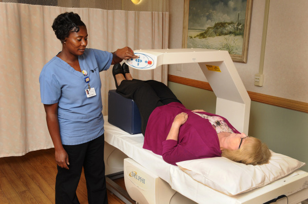 A dual X-ray absorptiometry (DXA) scanner at Wilmington Hospital measures bone density to support early detection and risk assessment for bone fragility in a target population of women age 50 to 80. Operating the equipment is Antoinette Brooks, CNMT.