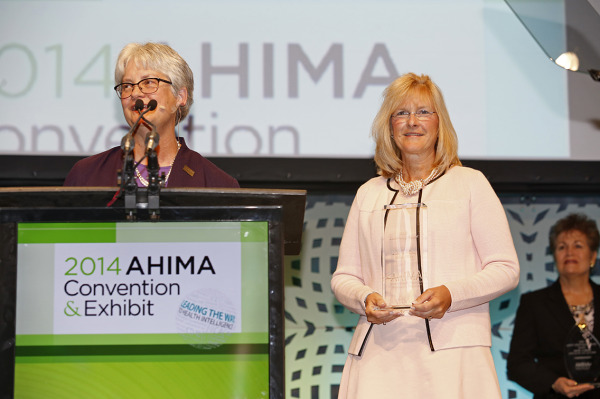 Kathy Westhaver, RHIA, CHPS, (right) receives the AHIMA Triumph Leadership Award.
