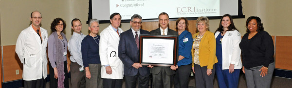 At the presentation of the Health Devices Achievement Award from ECRI Institute in November were Roger Kerzner, M.D., assistant medical director for Specialty Services, The Medical Group of Christiana Care; Sharon Kleban, senior systems analyst; Chris Coletti, M.D., FAAEM, FACP, medical director, Wilmington Hospital Emergency Department and Value Institute Scholar; Chris Carrico, RN, MSN, CPHQ, director of Patient Safety; Andrew Doorey, M.D., FACC, interventional cardiologist, Christiana Care Cardiology Consultants and Value Institute scholar; Robert Dressler, M.D., MBA, associate patient safety officer, vice chair for the Department of Medicine and director of Patient Safety and Quality for the Department of Medicine; Jim Keller, Jr., vice president, health technology and safety, ECRI Instiute. Donna Mahoney, MHCDS, director of Data Acquisition and Measurement; Michele Campbell, RN, MSM, CPHQ, FABC, vice president of Patient Safety and Accreditation; Brittney Henning, BSN, RN-BC, Patient Care Facilitator; and Tamekia Thomas, MSN, RN, PCCN, ACNS-BC, Critical Care Education Coordinator. The ECRI Institute is an independent nonprofit that researches best practice approaches to improving patient care.