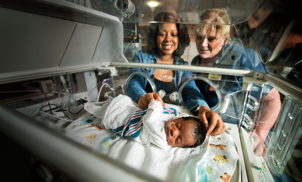 A nurse and mother care for a new baby in Christiana Hospital's neonatal intensive-care unit.