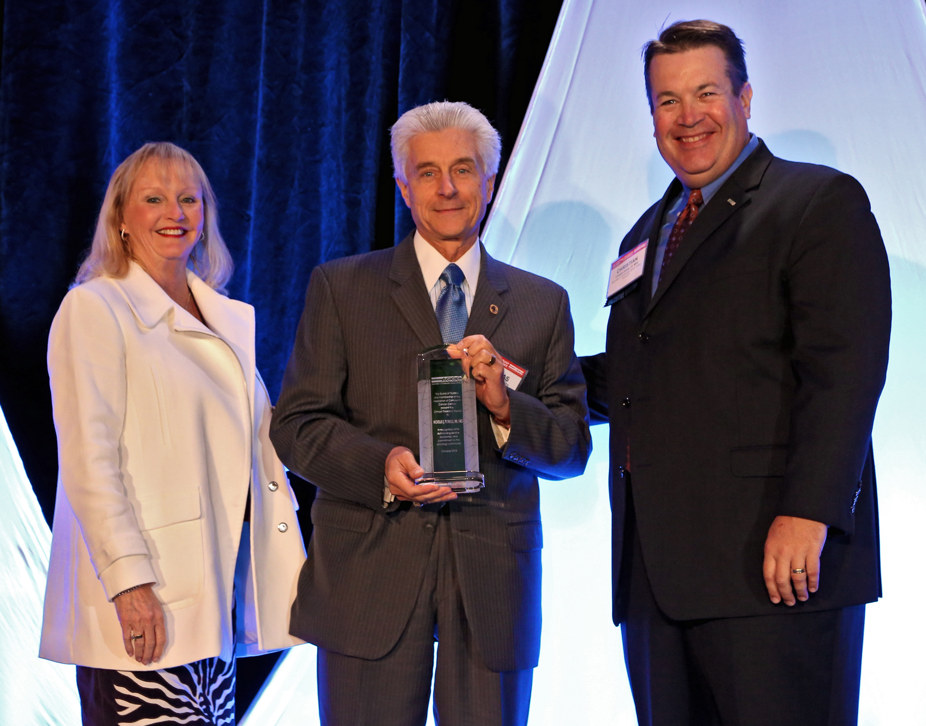 Nicholas J. Petrelli, M.D., FACS, (center) received the 2014 Clinical Research Award from the Association of Community Cancer Centers.