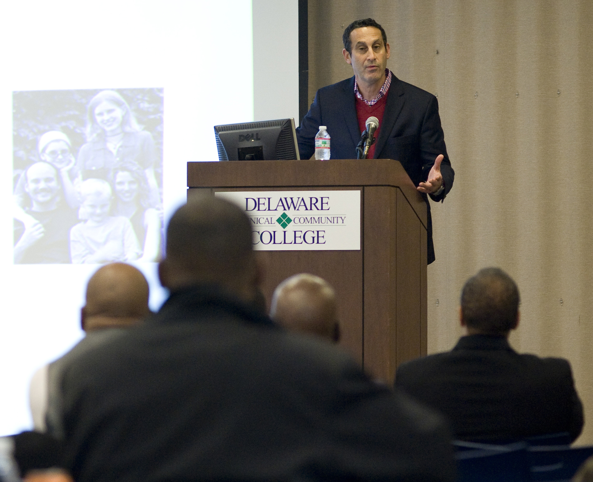 Adam Raben, M.D., Christiana Care radiation oncologist, speaks about the importance of cancer clinical trials at the Men of Color Summit. Blood Pressure Ambassadors, cancer outreach navigators, marketplace guides and adolescent health coordinators also attended.
