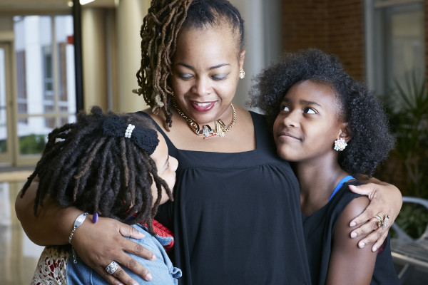 “This bracelet ... means life to me,” said Donyell Coleman, here with her daughters Devon and Seraiah. Because she is on the blood-thinning medication Coumadin, her medical alert bracelet is an important, potentially life-saving signal to first-responders, should she ever require care in an emergency situation.