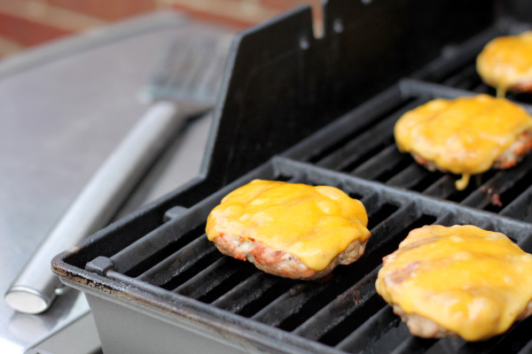 Turkey burgers cooking on the grill.