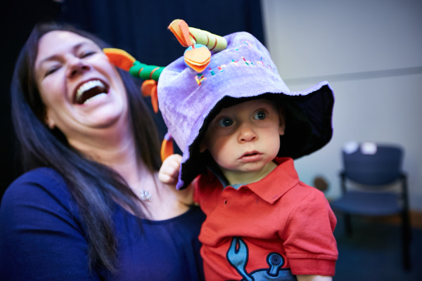 A happy birthday hat makes an affirming statement, as a mother and child prepare to make a memory in the photo booth at the NICU reunion.
