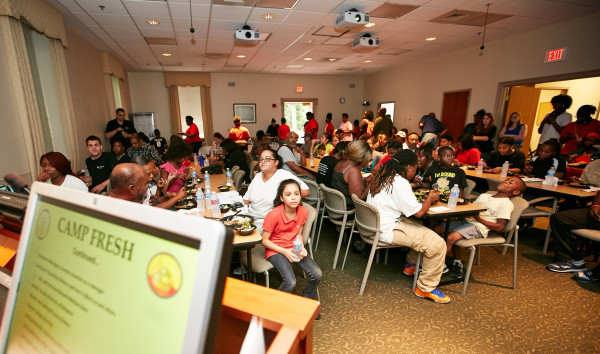 Campers and their families enjoy a health dinner to celebrate a successful summer at Camp FRESH.