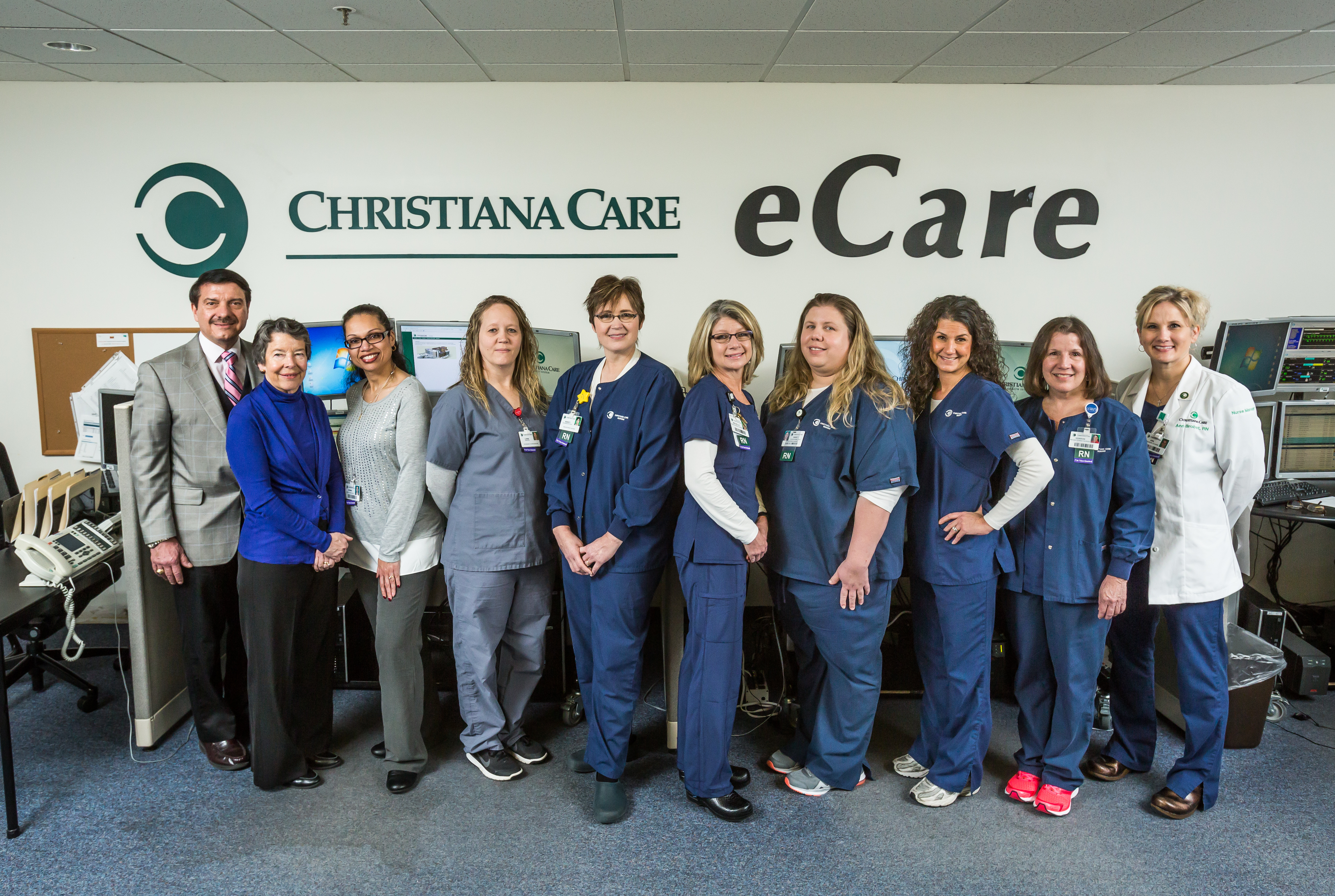 Albert Rizzo, M.D., medical director of eCare, and Virginia U. Collier, M.D., MACP, Hugh R. Sharp Jr. Chair of the Department of Medicine, joined eCare team for a 10th Anniversary photo, including Gemma Lowery Administrative Assistant VIII, Lori Draper, database coordinator, Nancy Galbreath BSN, RN, CCRN, Michelle Zechman BSN, RN, CCRN, Nancy Courchaine RN, Cheri Morrow RN CCRN, Sharon Finnegan BSN, RN, CCRN, and Ann Brobst MSN, RN, PCCN, nurse manager.