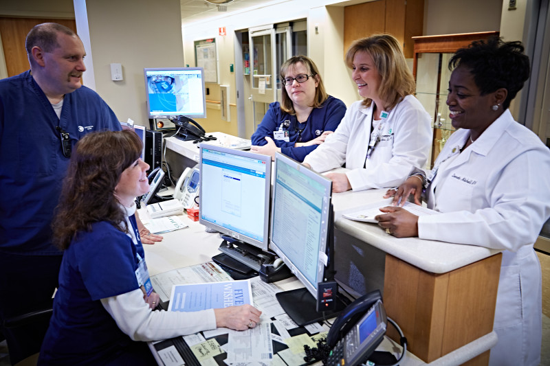 Sandy Wakai, MSN, RN, CCRN (center right), now of the Center for Advanced Joint Replacement, catches up with her WICU colleagues. She had moved the Beacon application forward while she was WICU nurse manager.