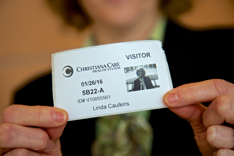 Nighttime visitors to the hospitals receive a temporary photo ID badge.