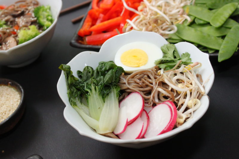Steamed baby bok choy, radishes, bean sprouts, hard boiled egg half, cilantro.