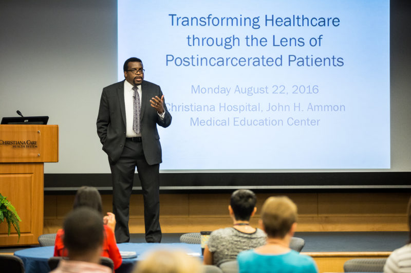 LeRoi S. Hicks, M.D., MPH, FACP, vice chair of Christiana Care's Department of Medicine, welcomes people to the "Transforming Healthcare through the Lens of Post-incarcerated Patients" symposium. The symposium was funded by Delaware- CTR- ACCEL, a $20 million, five-year grant from the National Institutes of Health (NIH), along with $5 million from the state of Delaware.