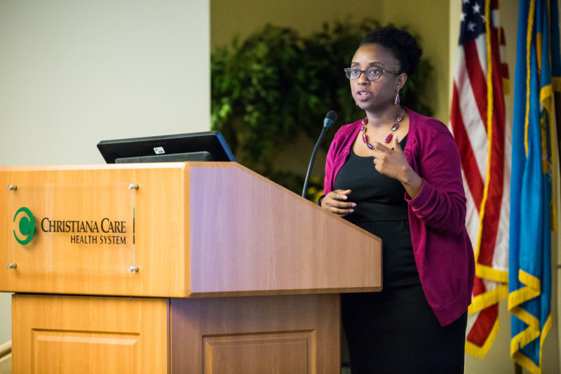 Nicole Redmond, M.D., Ph.D, MPH, a medical officer with the U.S. National Heart, Lung, and Blood Institute, speaks at the "Transforming Healthcare through the Lens of Post-incarcerated Patients" symposium.