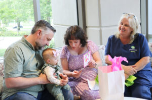 Gwen opens a gift from Cara. 